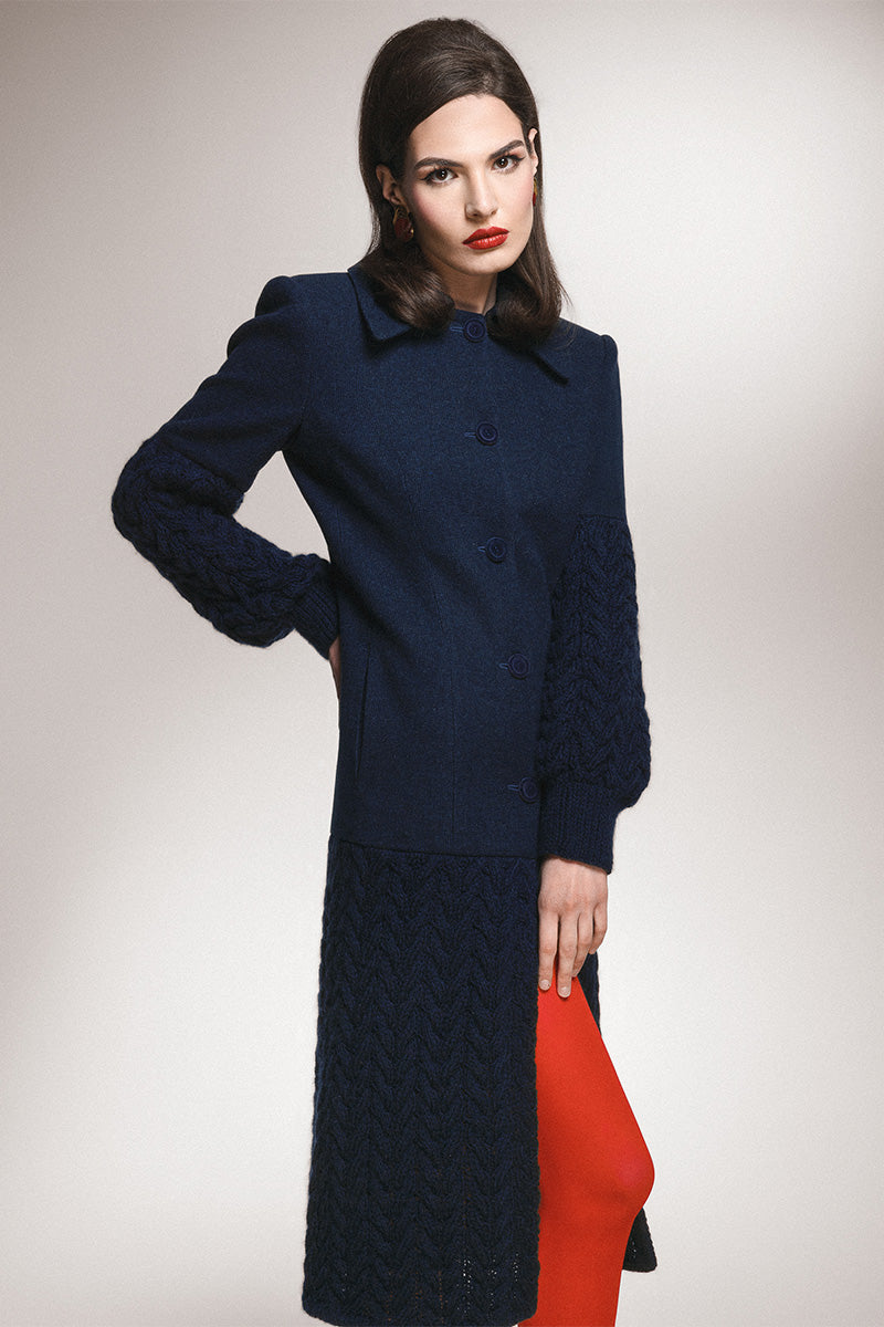 Liya long navy statement coat with tailored fit and classic lapel collar, styled on a hanger.