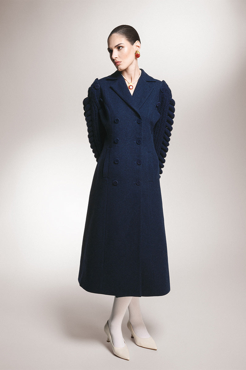 Liya long line navy coat-dress displayed on a hanger, showing its tailored fit and elegant design for sophisticated winter wear.