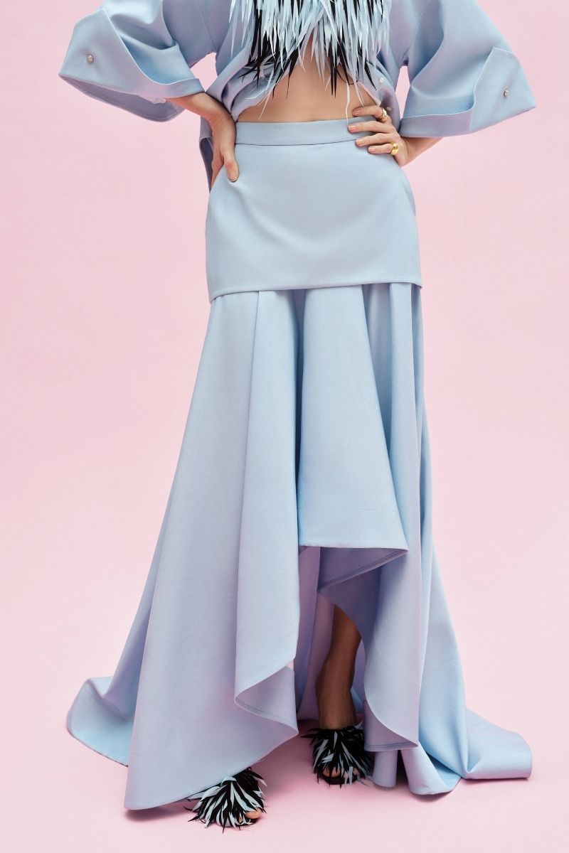 Jenny K Tran Colchester Maxi Skirt in flowy fabric with a high waist and tiered design, showcased in a full-length view.