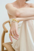 Gold Consciencia bracelet by Eugenia Ospina featuring a delicate chain and minimalist design on a white background.