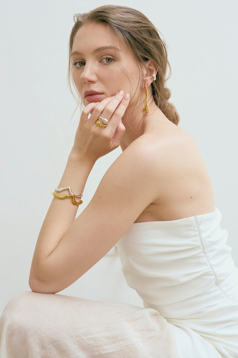 Gold Consciencia bracelet by Eugenia Ospina featuring a delicate chain and minimalist design.