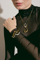 Silver Consciencia bracelet by Eugenia Ospina featuring a sleek, minimalist design with engraved detailing on a silver band.