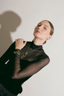 Silver Consciencia bracelet by Eugenia Ospina featuring a sleek, minimalist design and intricate engraved details.