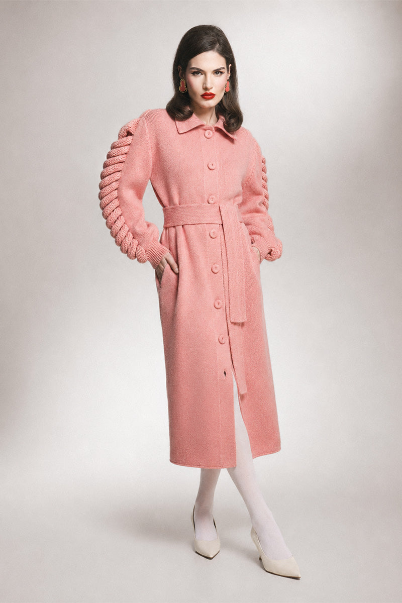 Liya dramatic pink knit belted coat showing a stylish, cozy design with a waist belt and textured knit fabric.