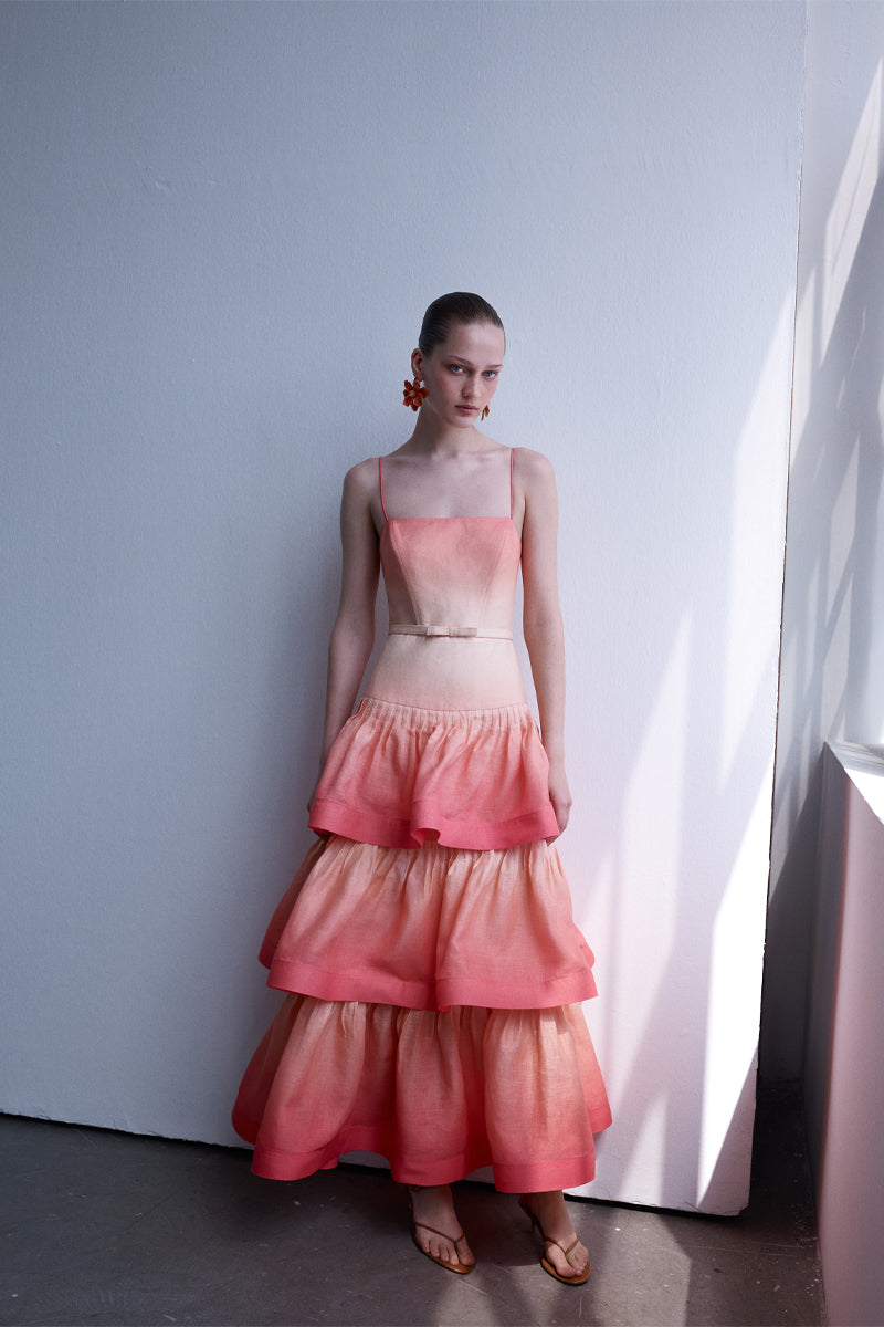 AISA Coralie Maxi Dress in flowing fabric with a vibrant coral color, featuring a sleeveless design and elegant length.