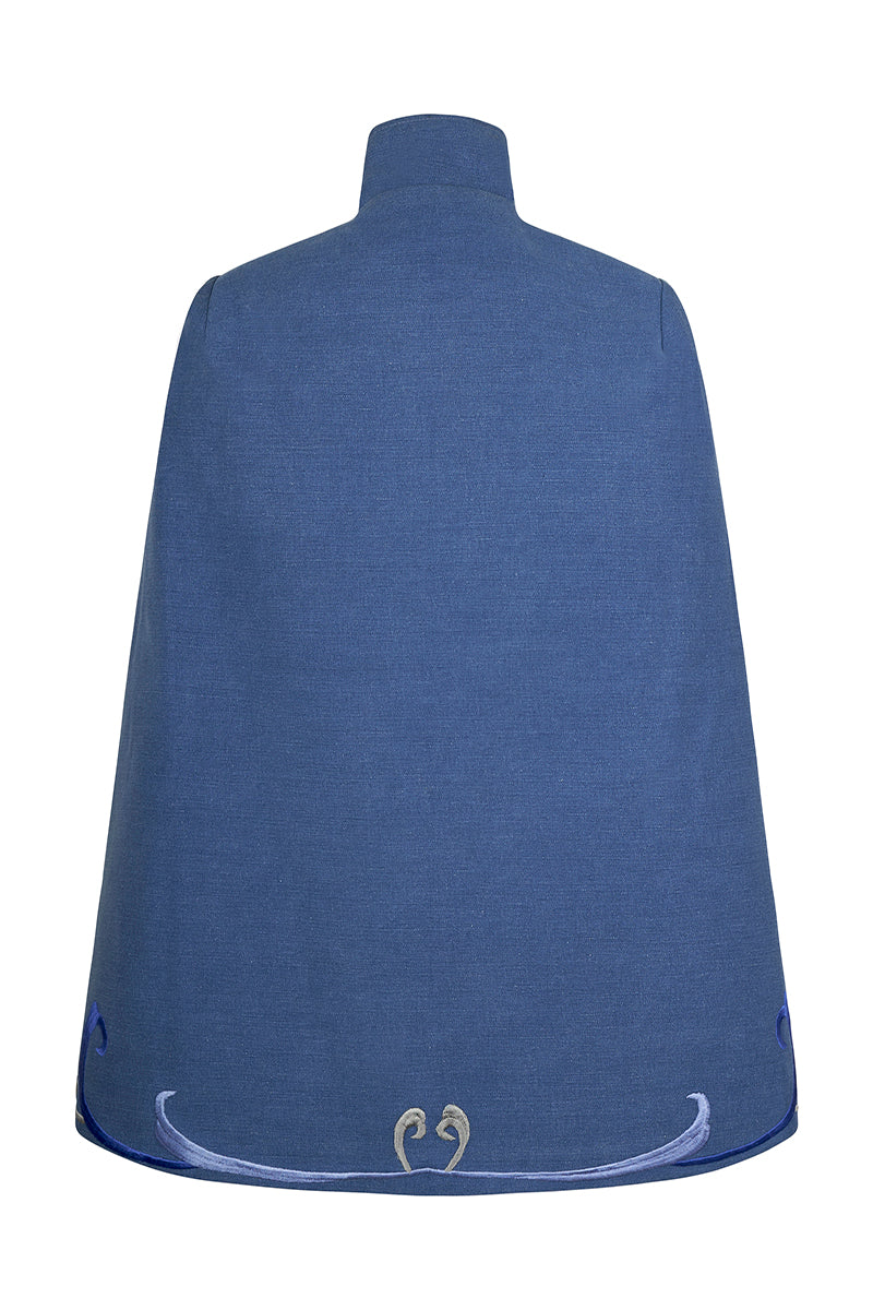 Nadya Shah Olympia denim cape jacket displayed on a hanger, showcasing its stylish design and texture.
