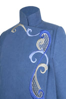 Nadya Shah Olympia denim cape jacket displayed on a mannequin, with detailed stitching and classic denim look.