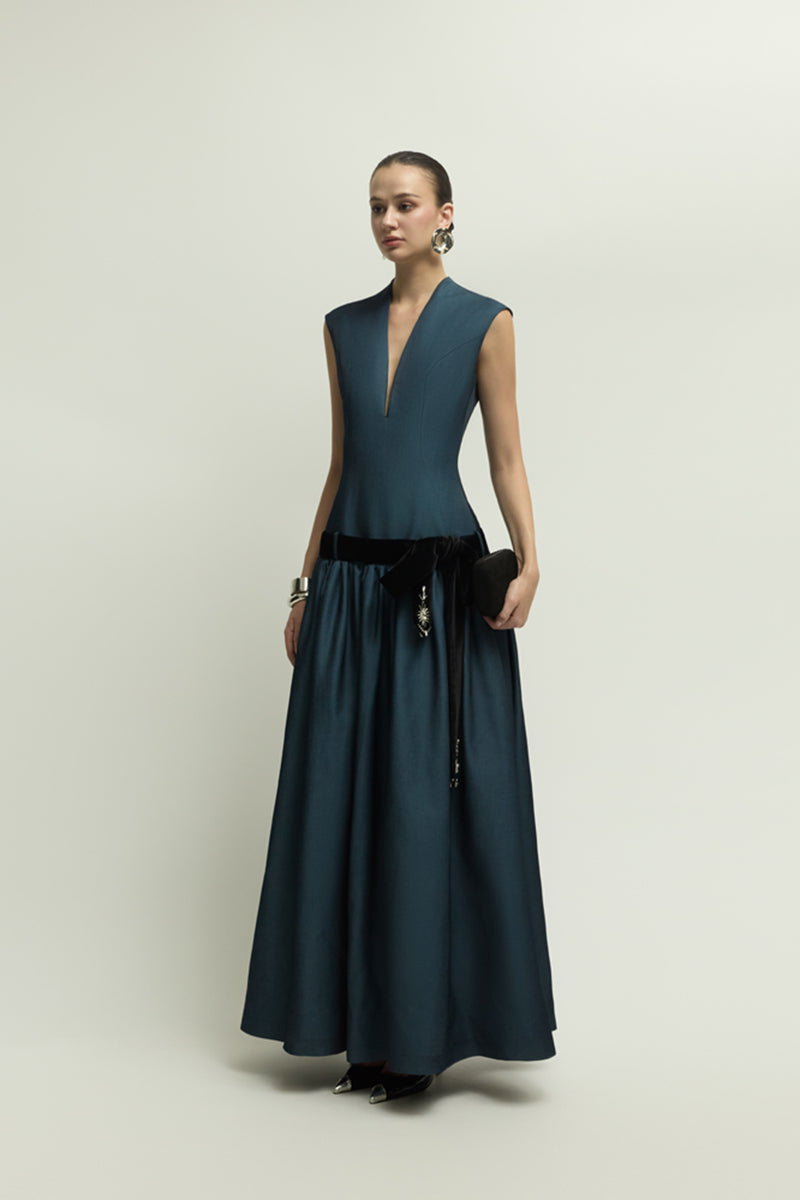 Dark blue Cricklade gown by Jenny K Tran, elegant evening dress with flowing fabric and sophisticated design.