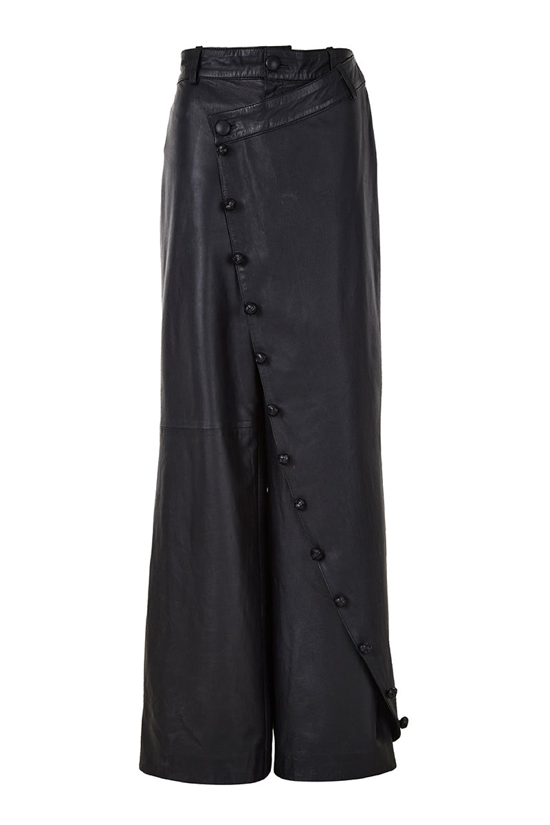 Black crossed leather pants by MAZ Manuela Álvarez, showcasing a stylish design with crossed leather panels and a sleek fit.