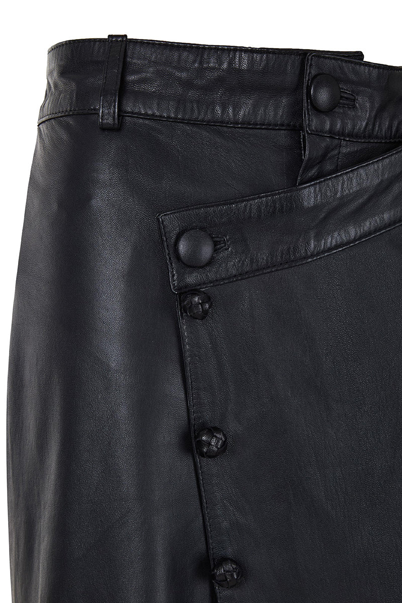 Black crossed leather pants by MAZ Manuela Álvarez, showcasing stylish design and fitted silhouette on a model.