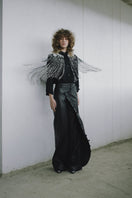Black crossed leather pants by MAZ Manuela Álvarez, featuring sleek design and fitted silhouette.