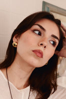 Sara & Flora MIDI cat eye earrings featuring sleek, oval-shaped design with vibrant green and black cat eye stones.