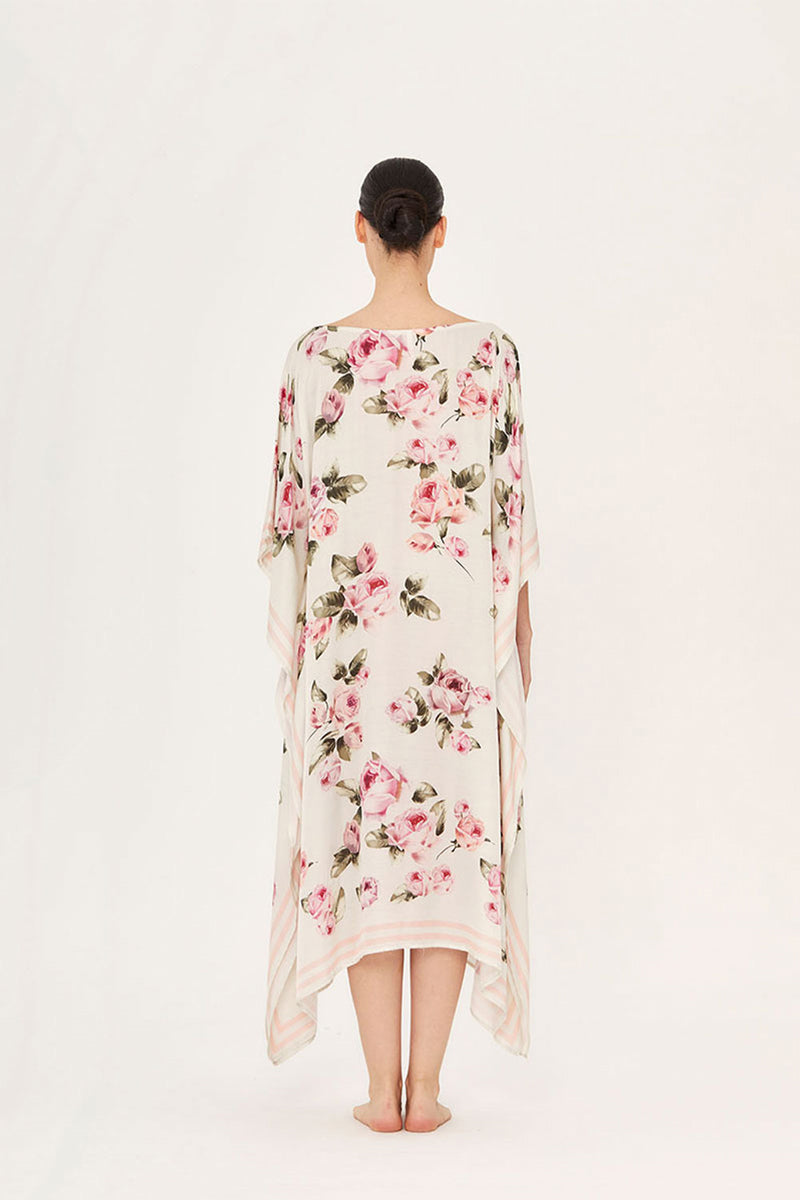 Aguaclara rose midi kaftan dress with flowing fabric and floral pattern, styled with long sleeves and a relaxed fit.