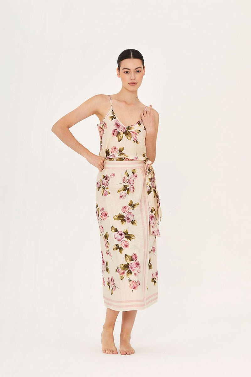 Aaguaclara rose wrap midi skirt in soft fabric, displayed on a model, featuring a stylish wrap design and feminine floral pattern.