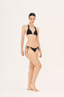 Black side tie bikini bottoms by Aguaclara with adjustable side ties and a sleek, minimal design for beach or swimwear.