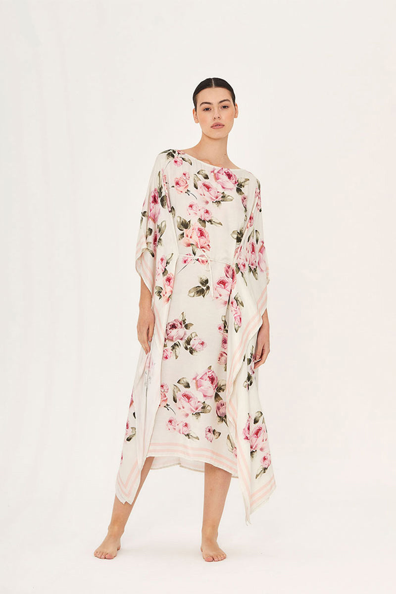 Aguaclara rose midi kaftan dress with flowing fabric and floral pattern, displayed on a model in a studio setting.