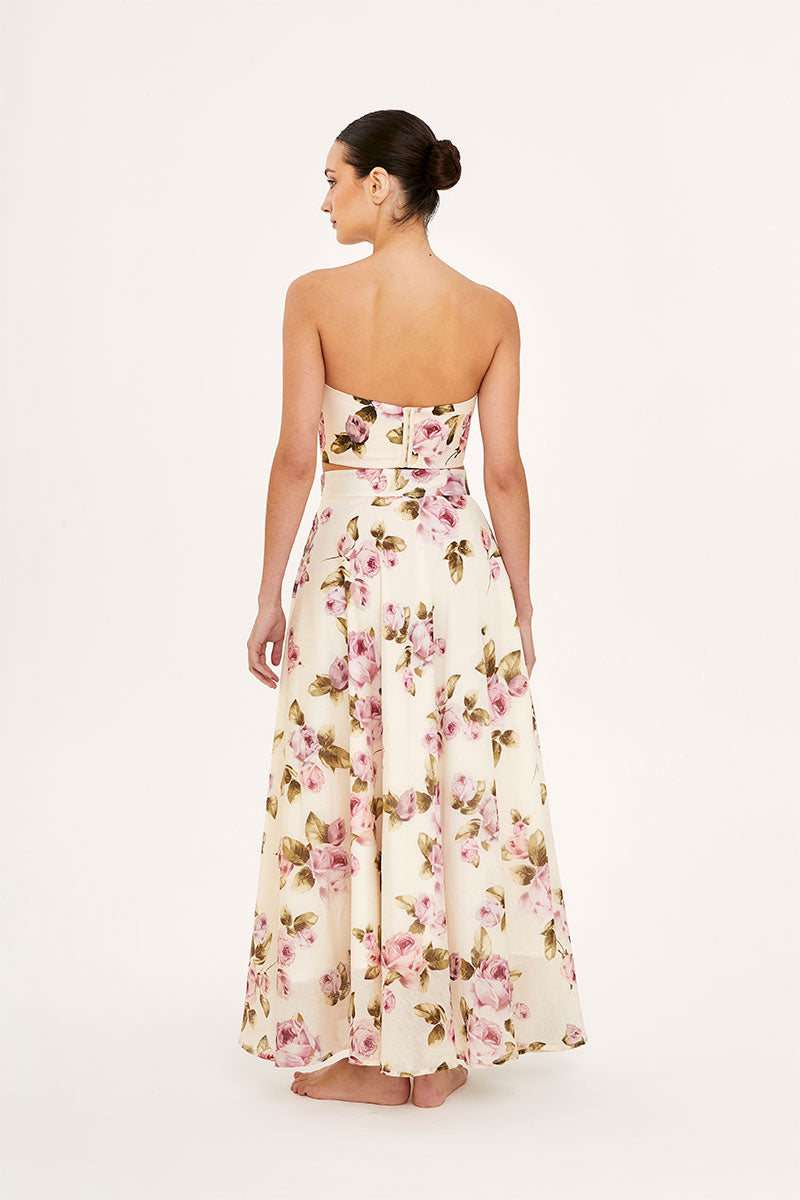 Aaguaclara Rose Maxi Skirt in flowy fabric with floral pattern, full-length design, and elastic waistband on a model.