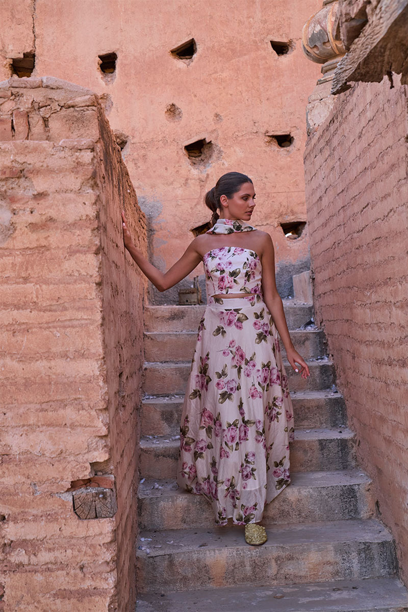 Aguaclara Rose Maxi Skirt with floral pattern, flowing fabric, and waist tie, styled as a bohemian maxi skirt for women.