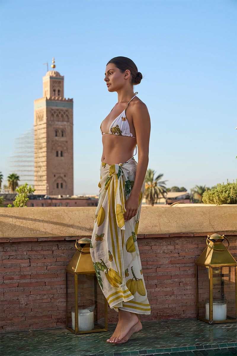 Aguaclara L'EST PAREO cover-up with colorful Marrakesh fruits print, lightweight fabric, worn as beach or poolside cover-up.