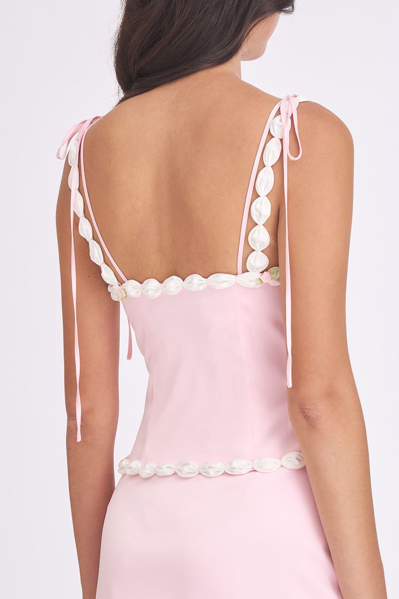 Light pink cake bustier top by Stolen Stores featuring a fitted design and decorative cake-inspired details.