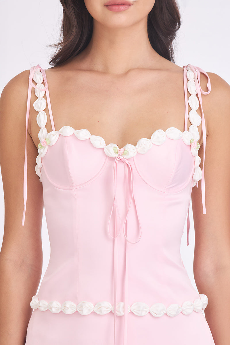 Light pink cake bustier top by Stolen Stores, featuring a fitted design and decorative details, perfect for stylish casual wear.