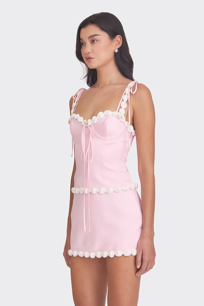 Light pink cake bustier top by Stolen Stores, featuring a fitted design with decorative details and a stylish neckline.