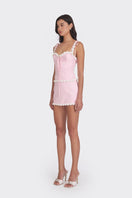 Light pink cake bustier top by Stolen Stores, featuring a fitted design and decorative details, perfect for stylish outfits.