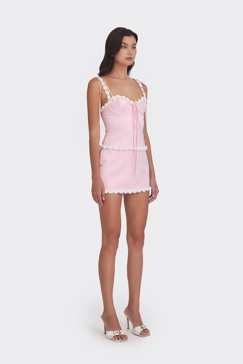 Light pink cake bustier top by Stolen Stores featuring a fitted design and decorative details.