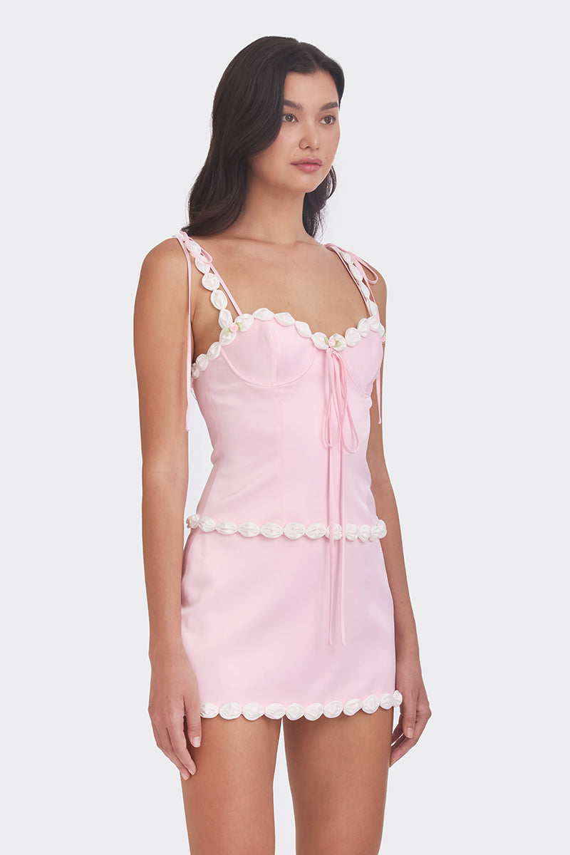 Light pink cake bustier top from Stolen Stores, featuring a fitted design with decorative details and adjustable straps.