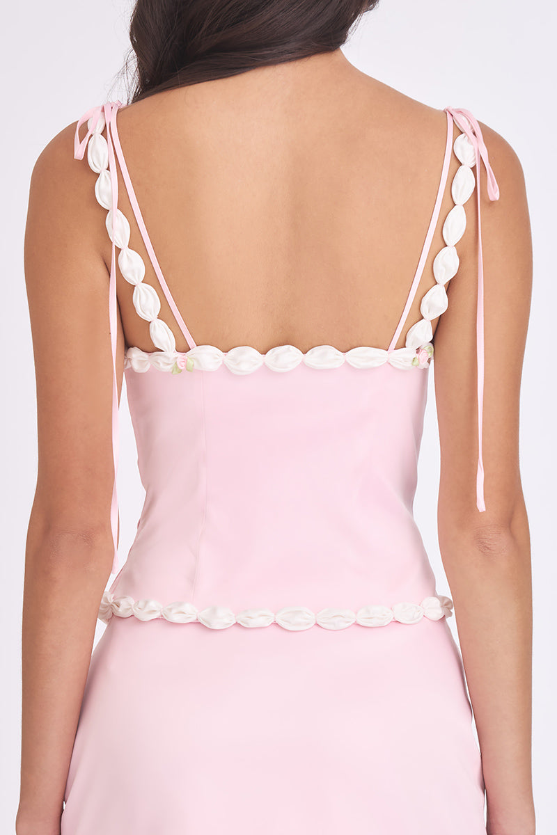Light pink cake bustier top by Stolen Stores, featuring a fitted design with decorative detailing and a stylish, trendy look.