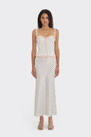 White polka dot bustier top by Stolen Stores featuring a cake-inspired design with a fitted silhouette.