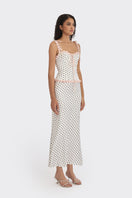 White polka dot bustier top from Stolen Stores with a cake-inspired design, featuring a fitted, sleeveless style.