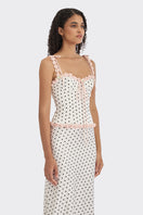 White polka dot cake bustier top by Stolen Stores featuring a fitted design and sweetheart neckline.