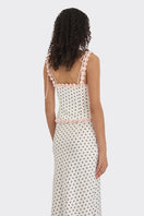 White polka dot bustier top from Stolen Stores with a cake-inspired design, featuring a fitted and stylish silhouette.