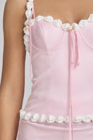 Light pink cake bustier top by Stolen Stores, featuring a fitted design and fashionable style.