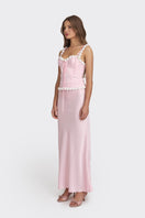 Light pink cake bustier top by Stolen Stores, featuring a fitted, stylish design, showcased on a model in a fashion photoshoot.