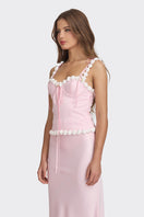 Light pink cake bustier top by Stolen Stores, featuring a fitted design and stylish details, displayed on a mannequin.