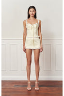 Light yellow cake bustier top by Stolen Stores featuring a fitted design and stylish neckline.