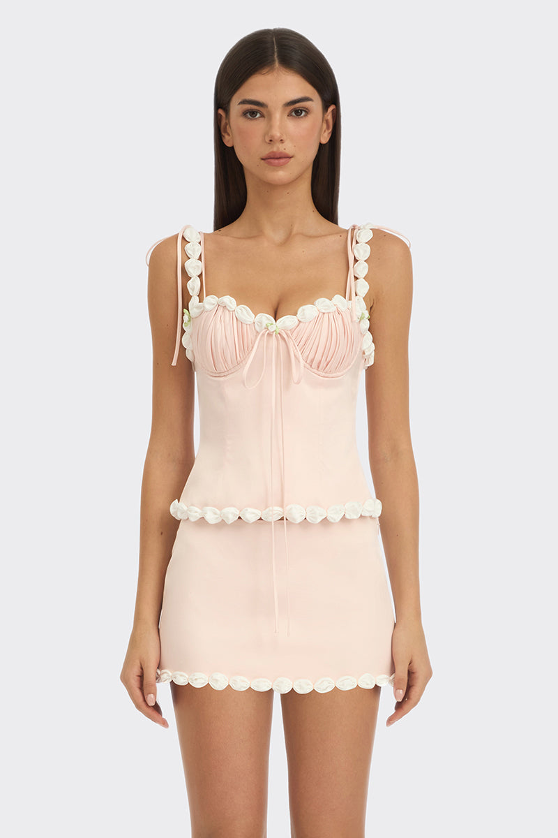 Light pink draped cake bustier top by Stolen Stores, featuring a fitted design and elegant fabric details.