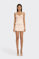 Light pink draped cake bustier top by Stolen Stores, featuring a fitted, stylish design with a textured, elegant fabric.