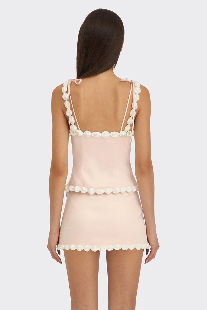 Light pink draped cake bustier top by Stolen Stores, featuring a fitted design and elegant draping detail.