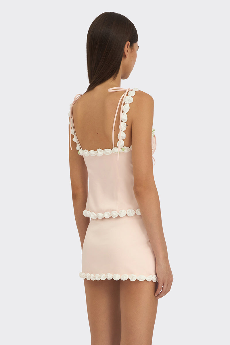 Light pink draped cake bustier top by Stolen Stores, featuring soft fabric and stylish design, showcased on a model.