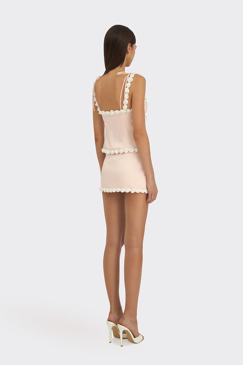 Light pink draped cake bustier top by Stolen Stores, featuring a fitted design and stylish fabric details.