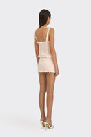 Light pink draped cake bustier top by Stolen Stores, featuring a fitted design and stylish fabric details.