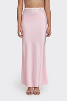 Light pink Cake maxi skirt by Stolen Stores, flowing fabric with a high waist and elegant length, shown on a model.