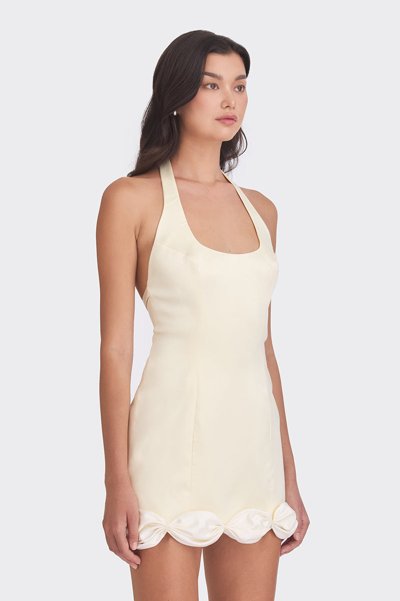 Light yellow Cake Bow mini dress by Stolen Stores, featuring a fitted silhouette and stylish design, shown on a model.