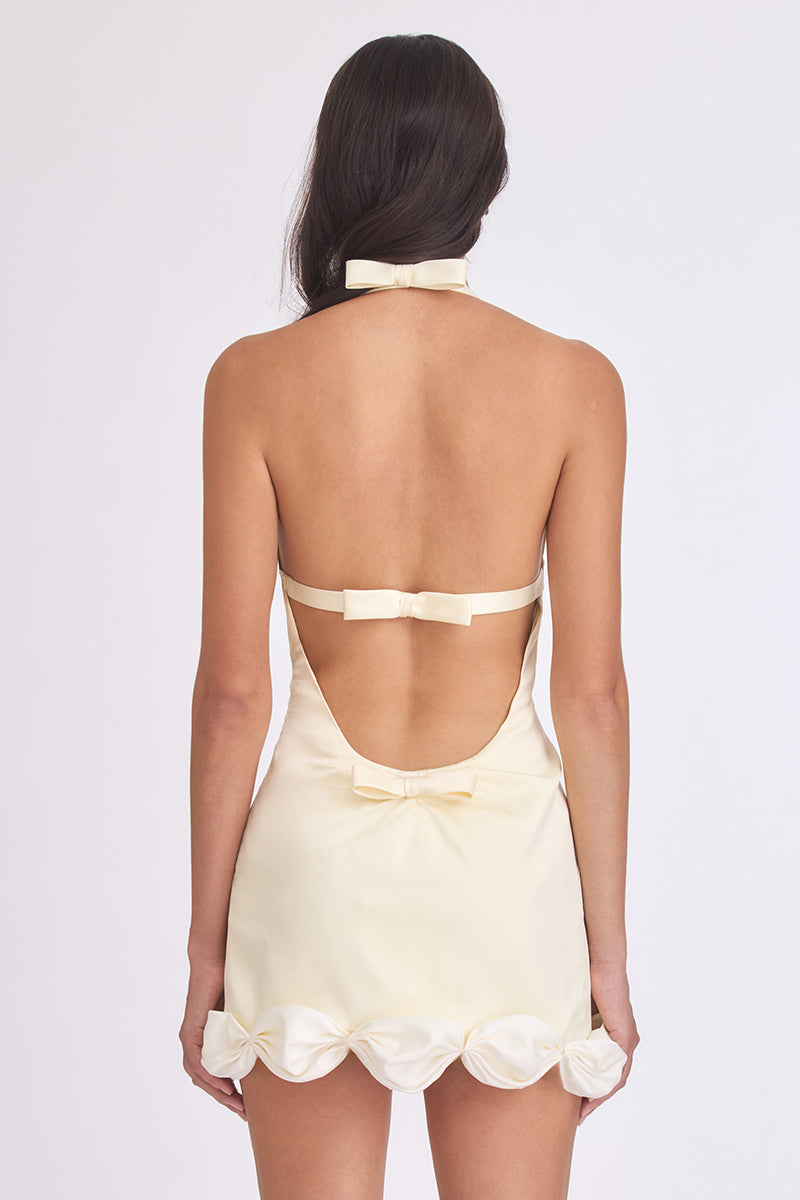 Light yellow Cake Bow mini dress by Stolen Stores, featuring a fitted silhouette and stylish design.