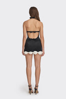 Black Cake Bow mini dress by Stolen Stores, featuring a stylish fit and bow detail, shown on a model.