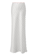 White Cake Maxi Skirt with black polka dots, flowing design, by Stolen Stores, styled with a casual top and accessories.