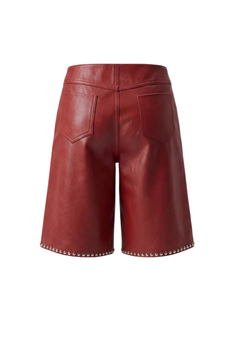 Red leather studded shorts by Double A, featuring a fitted design and metal stud embellishments, shown from the back.